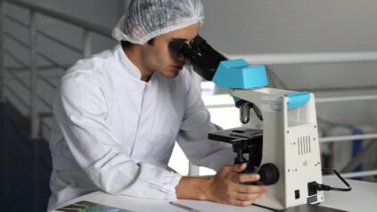 A medical staff using a microscope